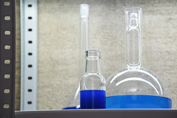 blue liquids in flasks for chemical and laboratory research