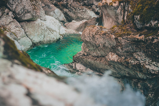 Beautiful water cascades or small waterfall in the valley of Lepena in Slovenian Julian Alps. Emerald green waterfalls in an enchanted forest. Sunikov vodni gaj.