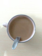 Close-up of a Spoon in a fresh Cup of Coffee.