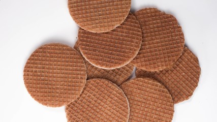 Top down view on round waffle cookies rotate or spin on the table. Sweet cookies lay on table. Traditional dutch and Holland stroopwafels