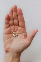 Used cermet dental crowns lie on the female palm