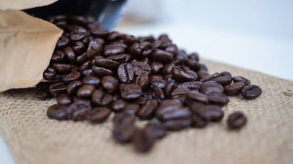 dark rose coffee bean, Black coffee cup on old wooden table top view.