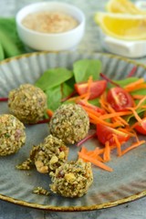 falafel balls made from seeds served with salad and tahini dressing