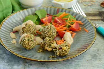 falafel balls made from seeds served with salad and tahini dressing
