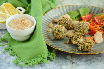falafel balls made from seeds served with salad and tahini dressing
