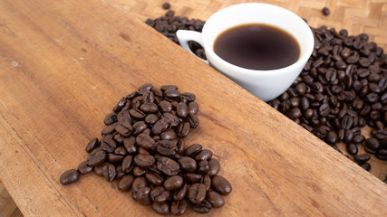 dark rose coffee bean, Black coffee cup on old wooden table top view.