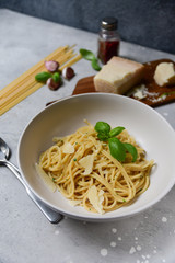Restaurant food delivery lunch at home. spaghetti with Parmesan cheese and herbs. food delivery to quarantine COVID-19. recipe homemade pasta. classic Italian cuisine. selective focus