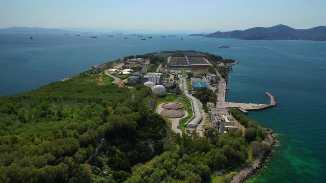 Aerial drone video of small island of Psitaleia a latest technology industrial sewage plant near port of Piraeus, Attica, Greece