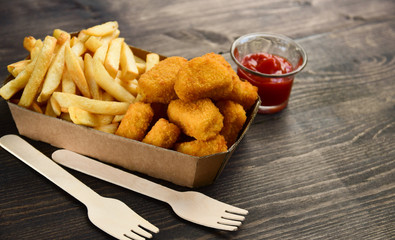 food delivery service. hot chicken nuggets and fries. take out food in a single use packaging made...