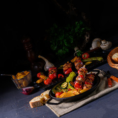 Fototapeta na wymiar Shish kebab with various vegetables and spice country potatoes