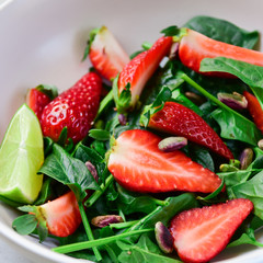 Restaurant food delivery lunch at home. Fitness food strawberry and  spinach salad. dish for spring and summer menu business lunch. selective focus.