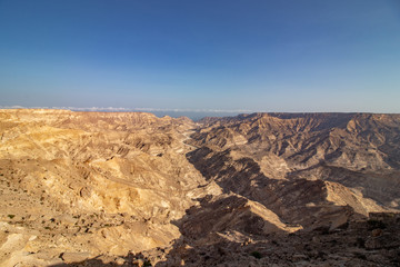 Fototapeta na wymiar view through Canyon to the ocean along the coastal road to Salalah in Oman