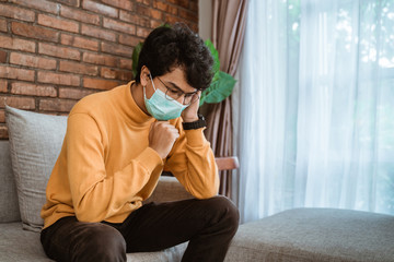 male on social distancing situation. virus symptoms. male wearing face masks coughing