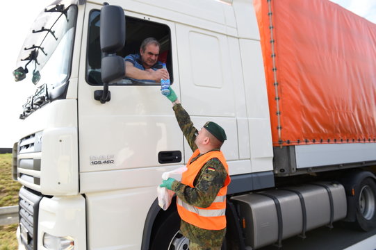 Soldiers of the German armed forces Bundeswehr deliver food supply for truck drivers trapped in a traffic jam on the highway A 4 near Goerlitz