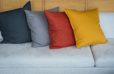 Modern colorful fabric pillows on gray cloth sofa design for office building interior or home and living decoration