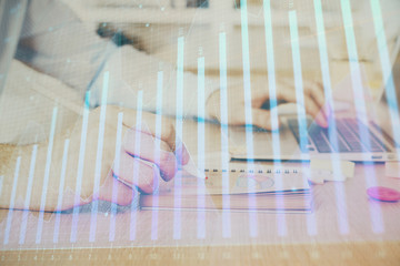 Multi exposure of financial graph with man works in office on background. Concept of analysis.