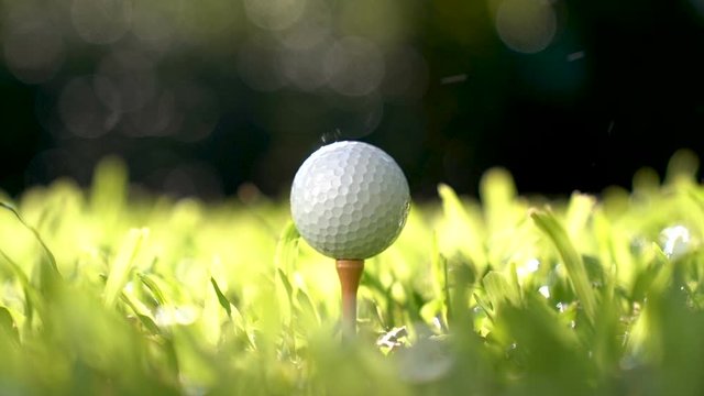Golfer hitting golf ball - slow motion .