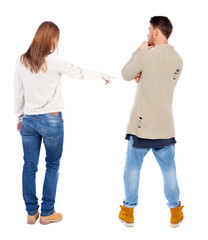 Back view of couple in sweater pointing.