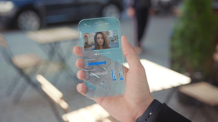 Income Call on his Transparent Phone. Future Smartphone. The Woman Use Smartphone with Futuristic Design. Concept of Digital Future. Technology of Holographic. Digital Technology. Business Background.