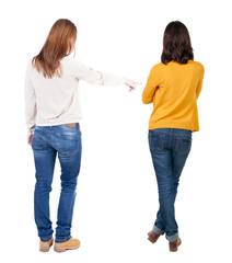 Back view of two pointing girl in sweater.