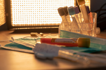 Medical face mask and pills with inscription Wuhan coronavirus 2019-nCoV on yellow table background. Novel coronavirus COVID-19 concept.