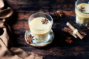 Masala tea in glass glasses on a dark wooden background. rustic  