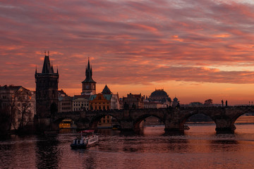 Colorful sunset and charles bridge on the background. Orange sky in Prague. 