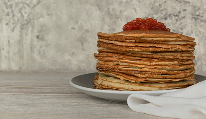 Homemade thin fresh crepes with red caviar breakfast or dessert. Close up