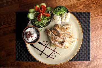 Special presentation of grilled chicken with salad and boiled vegetables