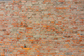 Brown color natural clay brick on old wall background