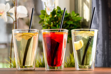 three homemade lemonade in a glass on a table