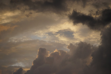 Dark Cumulus clouds against the blue sky.
