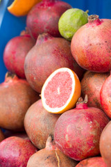 Pomegranates, oranges, limes on display, juicing stall, Morocco 