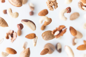 Assorted nuts flying above white background, levitation effect