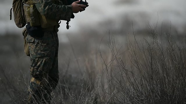 US army soldier holding automatic rifle in defense position during military exercise 