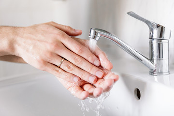 Washing hands under the water tap or faucet without soap. Global Hand washing Day Concept