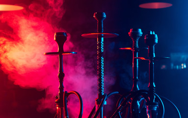 hookahs with shisha bowls and coals on the table in the interior of the lounge cafe