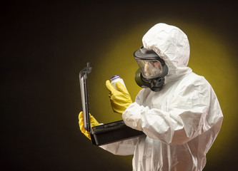a man in a biological protective suit wearing a gas mask with medication for coronavirus