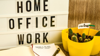 lightbox with text HOME OFFICE WORK with notebook pen and cactus and TO DO list, copy space wooden...