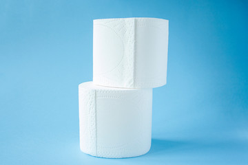 two Toilet paper roll on a blue background top view. Toilet paper purchase due to kronavirus concept. Personal hygiene and stopping the spread of the virus. Cleanliness, Hygiene, Sterility