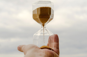  Hourglass in the hands of man. The time of human life. The ratio of humanity and time. The short...