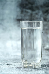 Glass of pure water on the grey background