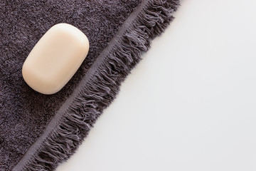 Personal hygiene kit on the white table. Soap and towel.