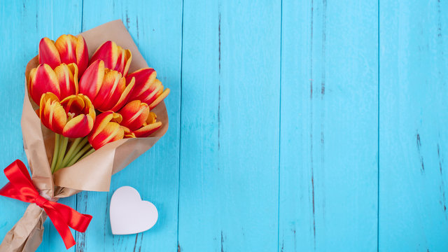 Tulip Flower Bunch, Mother's Day Design Concept - Beautiful Red, Yellow Bouquet Isolated On Blue Wooden Background, Top View, Flat Lay, Copy Space