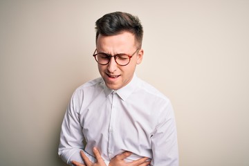 Obraz premium Young handsome business mas wearing glasses and elegant shirt over isolated background with hand on stomach because nausea, painful disease feeling unwell. Ache concept.