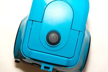 bagless vacuum cleaner in blue stands on a white background
