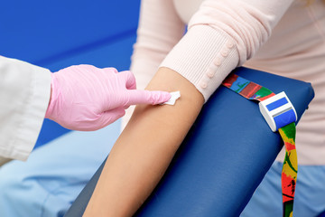 Fototapeta na wymiar Nurse disinfecting arm skin.