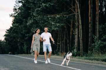 Portrait of happy senior couple in park with dog