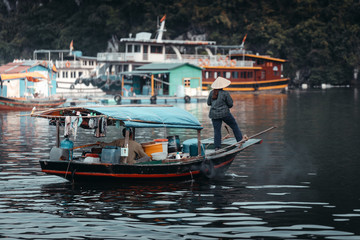 Vietnamese inhabitant on a traditional boat