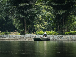 Vietnamese inhabitant on a traditional boat